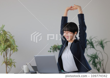 Business woman stretching her arms upwards 1 Business woman stretching her arms upwards 1 109774342