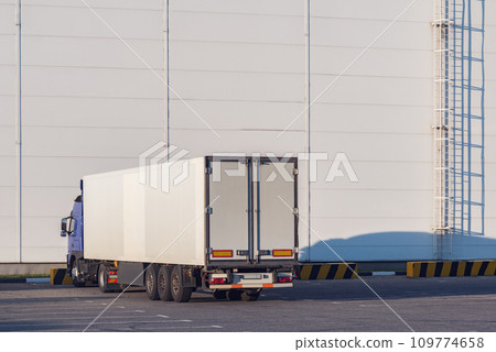 Freight truck stands by the wall of the storage. Freight truck stands by the wall of the storage. 109774658