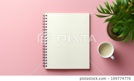 Mockup. Blank open notebook with blank sheets with a cup of hot drink and a green plant in a pot on a pink background. Top view. Flat lay. With copy space. Template for design. Spiral organizer. 109774776