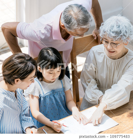 A family watching over an elementary school girl studying A family watching over an elementary school girl studying 109775483