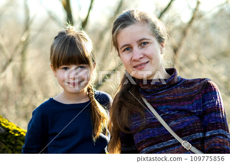 Young mom and her daughter girl together outdoors. 109775856