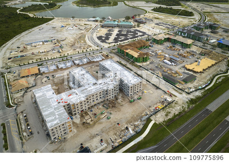 New apartment buildings under construction in american rural area. Development of residential housing in US suburbs. Real estate market in the USA New apartment buildings under construction in american rural area. Development of residential housing in US suburbs. Real estate market in the USA 109775896