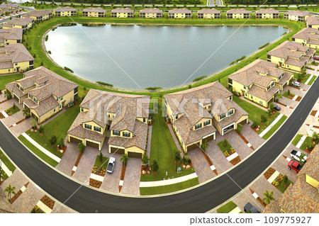 View from above of densely built residential houses near retention ponds in closed living clubs in south Florida. American dream homes as example of real estate development in US suburbs 109775927