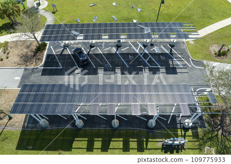 Hurricane wind damage to solar panels installed as shade roof over parking lot for parked electric cars. Failing of photovoltaic technology integrated in urban infrastructure 109775933