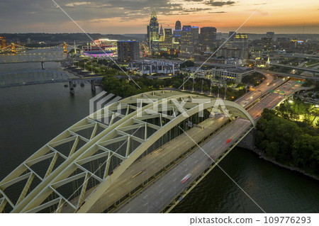 Aerial view of downtown district highway traffic in Cincinnati city, Ohio at night. Brightly illuminated high skyscraper buildings in modern American midtown 109776293