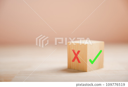 Decision-making concept portrayed by wooden block's green check mark and red x. Choice symbolism shown. Think With Yes Or No Choice. 109776519
