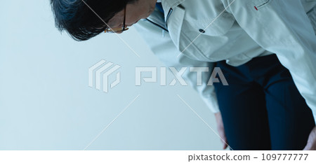 A man in work clothes apologizing A man in work clothes apologizing 109777777