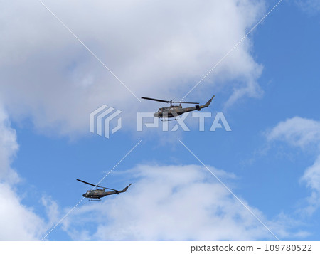 Japan Ground Self-Defense Force UH-1J helicopter flying in the blue sky 109780522