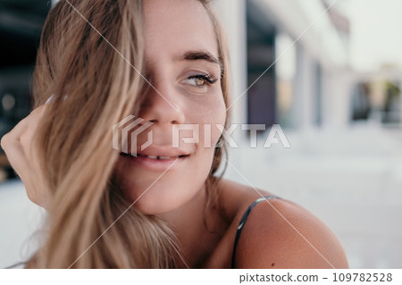 Happy woman portrait in cafe. Boho chic fashion style. Outdoor photo of young happy woman with long hair, sunny weather outdoors sitting in modern cafe. Happy woman portrait in cafe. Boho chic fashion style. Outdoor photo of young happy woman with long hair, sunny weather outdoors sitting in modern cafe. 109782528