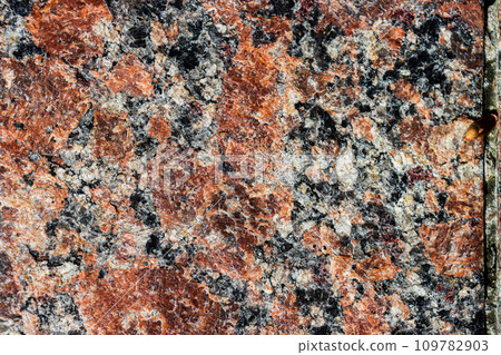 The texture of the stone surface is brown. 109782903