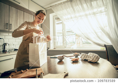 female bakery owner packs boxes for customer's order in birthday, Christmas package. small business entrepreneur and concept of food delivery 109783589
