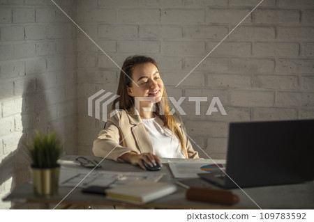 Young woman Calculating Success: Hands-on Strategies for Office Productivity Amidst Diagrams 109783592