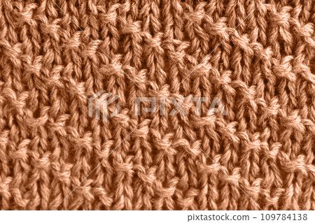 Peach wool knit with diagonal stripes. Color of the year 2024 109784138
