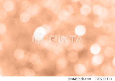 Blurred background with holiday lights. Showcasing the color of 2024 peach 109784144