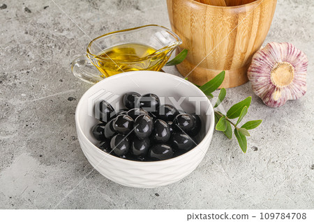 Black olives with oil and branch 109784708