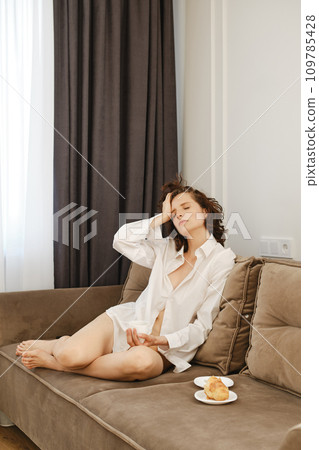 Tired woman trying to relax at home Tired woman trying to relax at home 109785428