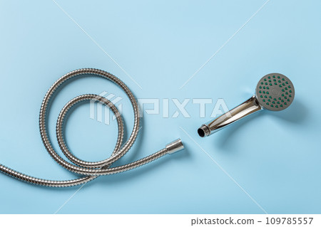 New hose and shower head over blue background. 109785557