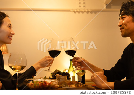 A couple making a toast with red wine A couple making a toast with red wine 109785578