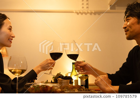 A couple making a toast with red wine A couple making a toast with red wine 109785579