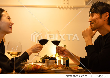 A couple making a toast with red wine A couple making a toast with red wine 109785580