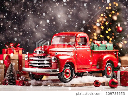 A red retro Christmas truck with gifts in the back non a Christmas background with bokeh in winter with snow. A holiday card for Christmas and New Year. A red retro Christmas truck with gifts in the back non a Christmas background with bokeh in winter with snow. A holiday card for Christmas and New Year. 109785653