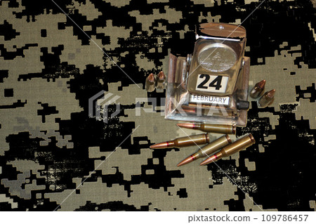 Bullets, vintage calendar and Ukrainian flag against black background 109786457