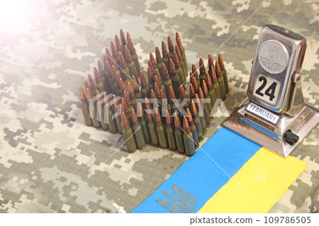 Cartridges for Kalashnikov assault rifle. War Concept. Ukrainian national symbol Cartridges for Kalashnikov assault rifle. War Concept. Ukrainian national symbol 109786505