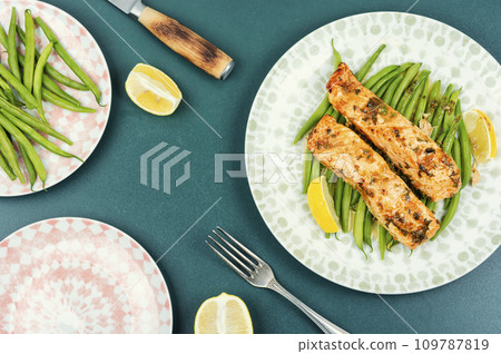 Baked salmon with green fresh vegetable. 109787819