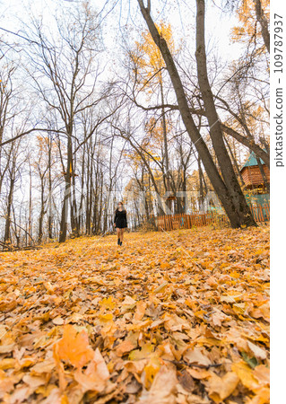Diversity young beautiful confident Indian Asian woman in black dress in fall outdoor. Happy and natural smiling female. Generation z and gen z youth concept Diversity young beautiful confident Indian Asian woman in black dress in fall outdoor. Happy and natural smiling female. Generation z and gen z youth concept 109787937