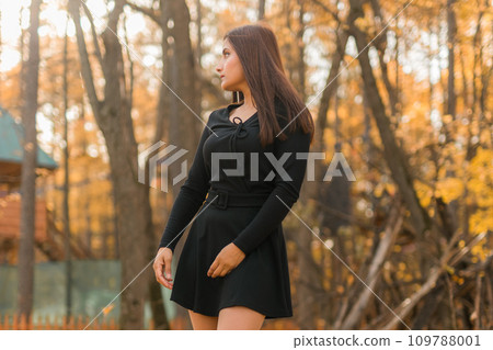 Beautiful indian woman generation z relaxing and feeling nature at autumn park in fall season copy space. Diversity and gen z youth Beautiful indian woman generation z relaxing and feeling nature at autumn park in fall season copy space. Diversity and gen z youth 109788001