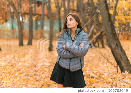 Beautiful indian woman generation z relaxing and feeling nature at autumn park in fall season copy space. Diversity and gen z youth Beautiful indian woman generation z relaxing and feeling nature at autumn park in fall season copy space. Diversity and gen z youth 109788049