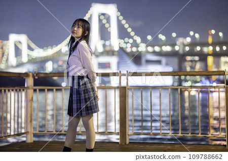 High school girls enjoying the illuminated coastal scenery 109788662