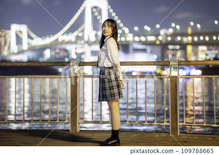 High school girls enjoying the illuminated coastal scenery 109788665