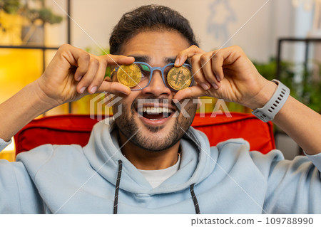 Indian man stock trader earning bitcoins online monitoring trading operations mining hold BTC coins 109788990