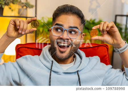 Indian man stock trader earning bitcoins online monitoring trading operations mining hold BTC coins Indian man stock trader earning bitcoins online monitoring trading operations mining hold BTC coins 109788998