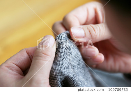 Close-up of hands sewing Close-up of hands sewing 109789783