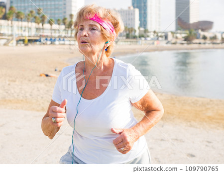 Old lady running beside beach Old lady running beside beach 109790765