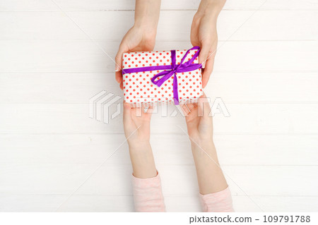 Girls hands holding lovely present box 109791788