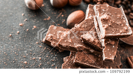 Chocolate and nuts on a black table 109792199