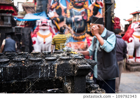 Smoke from candles with blurred people on the background 109792343