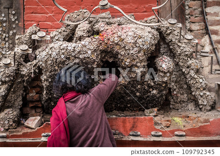 Nepalese woman worships toothache god Nepalese woman worships toothache god 109792345