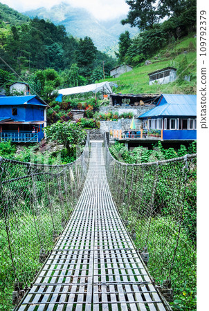 Suspension metal bridge in Annapurna trekking road, Nepal. 109792379