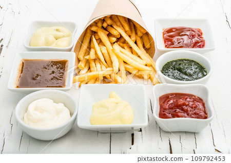 French fries with sauces on white background, top view 109792453