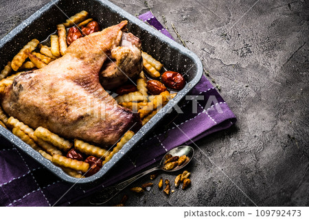 Turkey wing with french fries in baking tray top view Turkey wing with french fries in baking tray top view 109792473