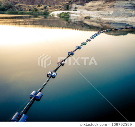 Aerial view of blue tube with barrels on the lake Aerial view of blue tube with barrels on the lake 109792599