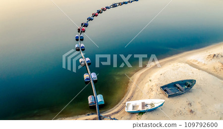 Aerial view of blue tube with barrels on the lake Aerial view of blue tube with barrels on the lake 109792600