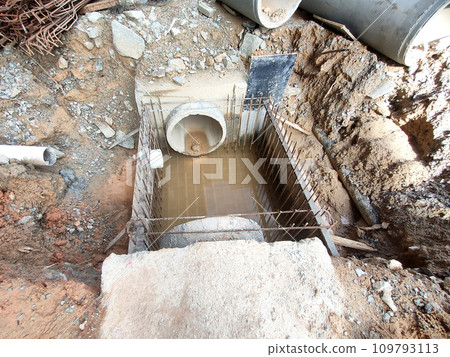 Melaka, Malaysia -February 2, 2022: Utility manhole under construction at a construction site. Built on site according to the engineer's design. Using plywood and timber as a construction mold Melaka, Malaysia -February 2, 2022: Utility manhole under construction at a construction site. Built on site according to the engineer's design. Using plywood and timber as a construction mold 109793113