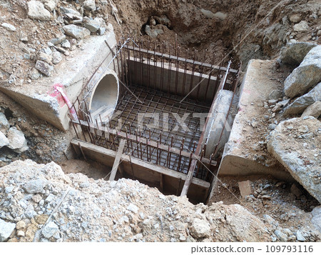 Melaka, Malaysia -February 2, 2022: Utility manhole under construction at a construction site. Built on site according to the engineer's design. Using plywood and timber as a construction mold Melaka, Malaysia -February 2, 2022: Utility manhole under construction at a construction site. Built on site according to the engineer's design. Using plywood and timber as a construction mold 109793116