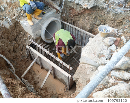 Melaka, Malaysia -February 2, 2022: Utility manhole under construction at a construction site. Built on site according to the engineer's design. Using plywood and timber as a construction mold Melaka, Malaysia -February 2, 2022: Utility manhole under construction at a construction site. Built on site according to the engineer's design. Using plywood and timber as a construction mold 109793120