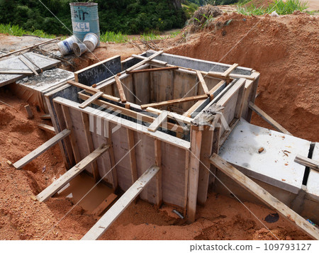 Melaka, Malaysia -February 2, 2022: Utility manhole under construction at a construction site. Built on site according to the engineer's design. Using plywood and timber as a construction mold Melaka, Malaysia -February 2, 2022: Utility manhole under construction at a construction site. Built on site according to the engineer's design. Using plywood and timber as a construction mold 109793127